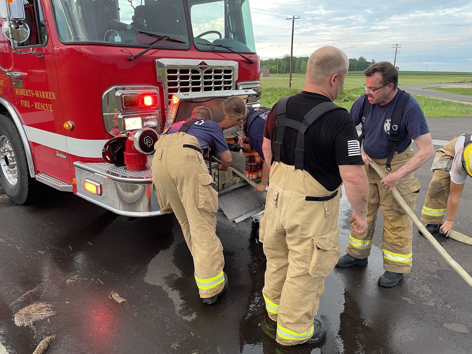 Roberts-Warren Fire-Rescue crew working together at the back of the engine